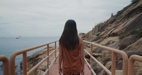 Canvas Print - Woman enjoy hiking in Po Toi island in Hong Kong