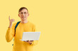 © Pixel-Shot - Male student with laptop on color background