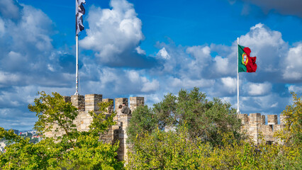 Wall Mural - Portugal flag against the blue sky in Lisbon castle.