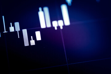 Abstract financial trading graphs and digital number of foreign exchange market trading on monitor. Background of gold and blue digital chart to represent stock market trend.