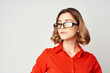 woman in red shirt wearing glasses manager work office
