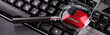 Black keyboard from a computer with a magnifying glass. Enter and switch keys. Tool. Press. Red enter button enlarged with magnifying glass