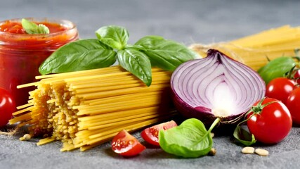 Canvas Print - raw spaghetti with tomato sauce and basil