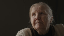Senior Woman Sitting Indoor With Soft Window Light