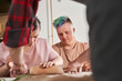 © Yakobchuk Olena - Teacher holding rolling pin and showing to his students with special needs