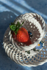 Sticker - Vertical shot of a fresh strawberry in a white small basket