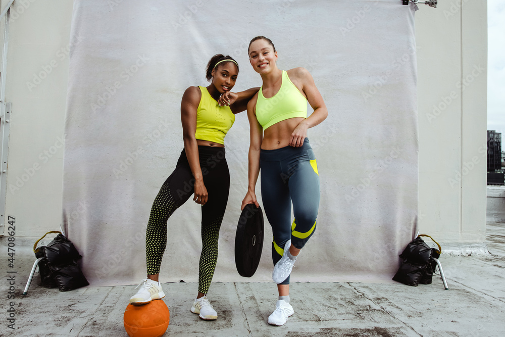 Female athletes posing after workout session - obrazy, fototapety, plakaty 