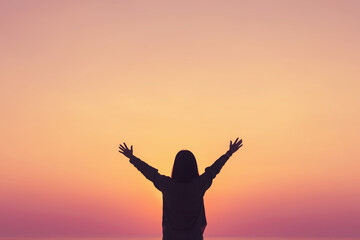 Canvas Print - Copy space of woman rise hand up on sunset sky at beach and island background.