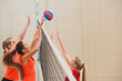 teenage girls at volleyball practise in indoor sports hall