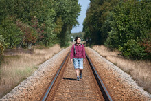 Woman Hiking On Train Tracks In The North Of Denmark