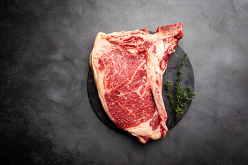 Wall Mural - Raw fresh meat T-bone beef Steak on black background, top view