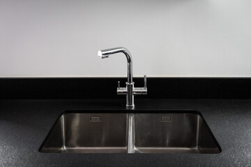 Wall Mural - A double bowl stainless steel kitchen sink in a modern style, steel chrome water tap in the kitchen