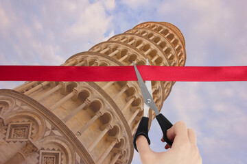 Wall Mural - End of quarantine covid-19. The beginning of travel, the opening of borders. Hand cuts a red ribbon with scissors overlooking the Leaning Tower of Pisa, Italy