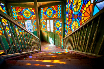 Wooden stair with colored kaleidoscopic balcony in old antique house in Tbilisi, Georgia country