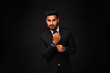 © Тарас Нагирняк - Portrait of young stylish indian business man in black suit on black isolated background