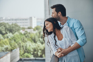 Sticker - Beautiful young couple smiling and bonding while spending together