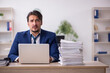 © Elnur - Young male employee unhappy with excessive work in the office