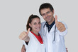© fabio - Doctor and nurse hug each other smiling and show thumbs up. Collaboration concept between doctor and nurse.