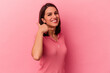 © Asier - Young caucasian woman isolated on pink background showing a mobile phone call gesture with fingers.