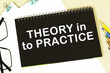 © PanArt - THEORY IN TO PRACTICE. Office supplies, alarm clock, block with text. Business, education concept. flat lay
