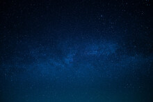 Milky Way. Night Starry Sky. Various Shades Of Blue. Small Stars Twinkle In The Sky. There Is No One In The Photo. High Angle View. Wallpaper. Background. Texture.