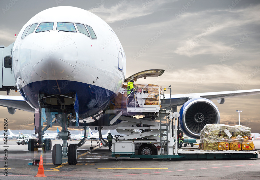 loading cargo into the airplane before departure with nice sky - obrazy, fototapety, plakaty 