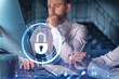 © VideoFlow - Two colleagues working together to protect clients confidential information and cyber security. IT hologram padlock icons modern office background at night time