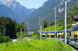 Blue and yellow BOB train between Grindelwald and Zweilütschinen at Bernese Highland on a beautiful summer day. Photo taken July 20th, 2021, Lauterbrunnen, Switzerland.