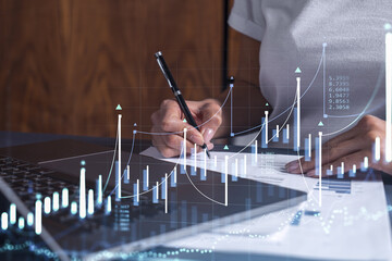 Wall Mural - A client in casual wear is signing the contract to invest money in stock market. Internet trading and wealth management. Forex and financial hologram chart over the desk. Women in business concept.