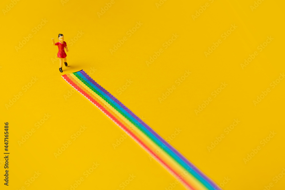 little girl figure on the LGBT rainbow path - obrazy, fototapety, plakaty 