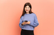 © luismolinero - Young Ukrainian girl isolated on pink background surprised and sending a message