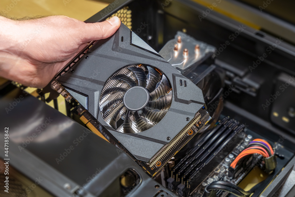 Installing a video card on the motherboard. The technician installs ...