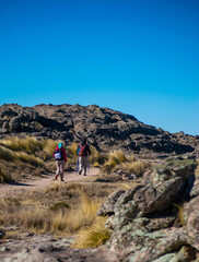 two people trekking in the high peaks