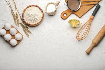 Wall Mural - Ingredients for preparing bakery and utensils on light background