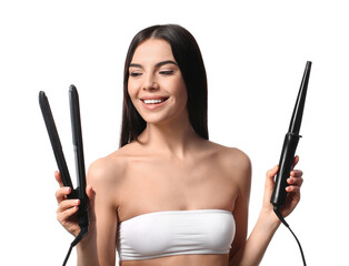 Wall Mural - Beautiful young woman with flattening and curling irons on white background