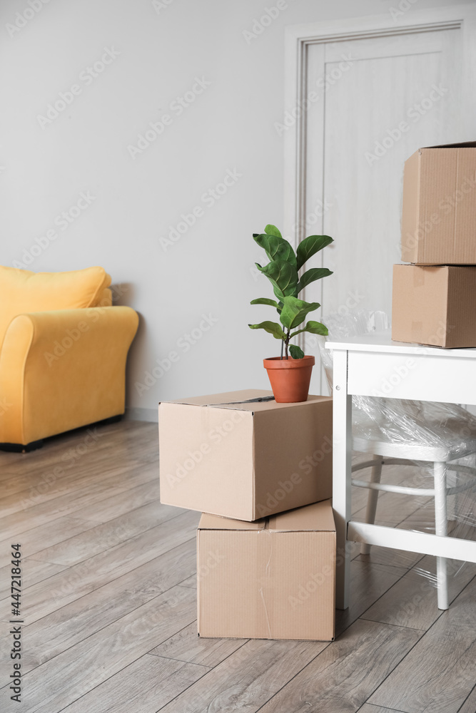 Cardboard boxes with belongings in room on moving day