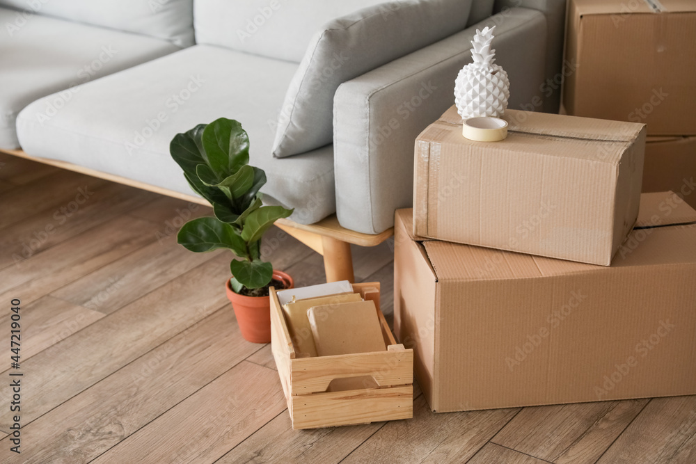 Cardboard boxes with belongings in room on moving day