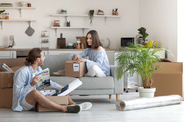 Sticker - Young couple with cardboard boxes in their new house on moving day