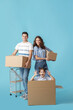 © Pixel-Shot - Happy family with moving boxes on color background