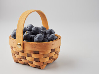 Wall Mural - Blueberry fruit top view isolated on a white background, flat lay overhead layout with mint leaf, healthy design concept.