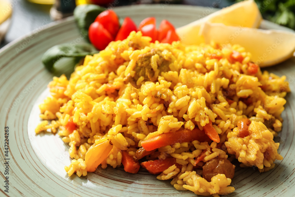 Plate with tasty pilaf on table, closeup