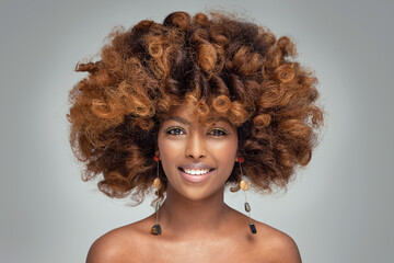 Wall Mural - Beauty portrait of happy afro american woman with culry hairstyle and glamour colorful makeup.