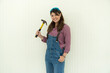 © godji10 - Females carpenter holding a hammer near white background