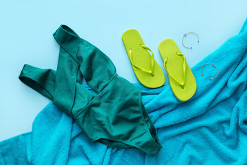 Set of beach accessories on color background