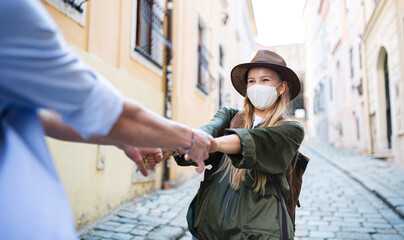 Wall Mural - Young couple travelers in love having fun when sightseeing in city on holiday, coronavirus concept.