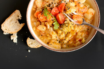 Wall Mural - Vegan stew of vegetables on a dark background top view