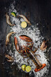Fresh raw lobster on ice on dark textured background. Space for text. Top view. High quality photo
