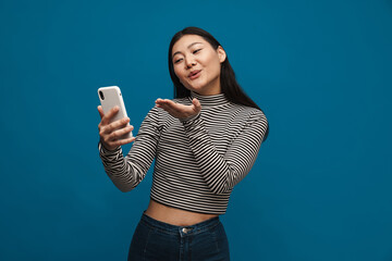 Wall Mural - Portrait of a casual young asian woman standing