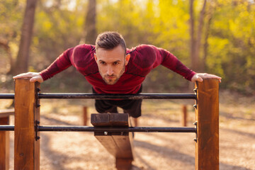 Wall Mural - Man exercising outdoors, doing push ups