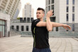 © New Africa - Young man stretching before morning fitness outdoors